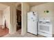 Dated kitchen with white appliances next to a door leading to another room at 114 S 5Th St, Albemarle, NC 28001
