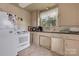 Outdated kitchen with white appliances and a window providing natural light at 114 S 5Th St, Albemarle, NC 28001