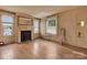 Bright living room with a fireplace, hardwood floors, and large windows at 114 S 5Th St, Albemarle, NC 28001