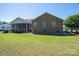 Expansive backyard view with a screened porch and brick exterior, perfect for outdoor enjoyment at 118 Sir Gregory Dr, Shelby, NC 28152