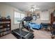 Cozy bedroom features a ceiling fan, large windows, and a treadmill for convenient in-home workouts at 118 Sir Gregory Dr, Shelby, NC 28152