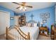 This bedroom is well-lit and features a wooden bed frame, ceiling fan, and a closet at 118 Sir Gregory Dr, Shelby, NC 28152