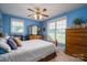 This bedroom features a ceiling fan, two windows for plenty of light, and a dresser with storage at 118 Sir Gregory Dr, Shelby, NC 28152