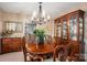 This dining room features a chandelier, hardwood table, and a built-in hutch for storage at 118 Sir Gregory Dr, Shelby, NC 28152