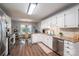 Charming eat-in kitchen with stainless appliances, white cabinetry and modern lighting at 118 Sir Gregory Dr, Shelby, NC 28152