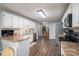 Bright kitchen features stainless steel appliances, white cabinets, and hardwood floors at 118 Sir Gregory Dr, Shelby, NC 28152