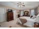 The main bedroom has a ceiling fan, dresser, and views of the neighborhood through the windows at 118 Sir Gregory Dr, Shelby, NC 28152