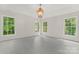 Bright bedroom featuring hardwood floors and three large windows providing ample natural light at 121 Northampton Dr, Mooresville, NC 28117