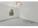 Neutral bedroom offers a ceiling fan and a window bringing natural light into the room at 121 Northampton Dr, Mooresville, NC 28117