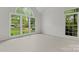 Bright bedroom with large windows offering views of the surrounding greenery at 121 Northampton Dr, Mooresville, NC 28117