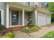 View of the front exterior with a two-car garage and blue front door with manicured landscaping at 121 Northampton Dr, Mooresville, NC 28117