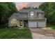 Two-story home featuring a two-car garage, manicured lawn, and a welcoming front porch in a lovely neighborhood at 121 Northampton Dr, Mooresville, NC 28117