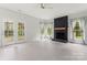Bright living room with dark brick fireplace, large windows, and french doors at 121 Northampton Dr, Mooresville, NC 28117