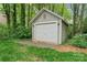 Exterior view of backyard shed with white garage door and siding, providing ample storage space at 121 Northampton Dr, Mooresville, NC 28117