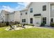 Well-maintained backyard with a fire pit, chairs, and lush green lawn at 1210 Langdon Terrace Dr, Indian Trail, NC 28079