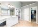 Bright bathroom featuring a walk-in closet, vanity, and tiled floors at 1210 Langdon Terrace Dr, Indian Trail, NC 28079