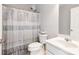 Cozy bathroom with shower, gray and white shower curtain, sink and toilet at 1210 Langdon Terrace Dr, Indian Trail, NC 28079