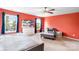 Bright bedroom featuring an orange wall, neutral carpet, windows and a ceiling fan at 1210 Langdon Terrace Dr, Indian Trail, NC 28079