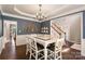 Elegant dining room with chandelier, wainscoting, and a large table setting at 1210 Langdon Terrace Dr, Indian Trail, NC 28079