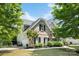 Charming brick home featuring lush landscaping and a two-car garage with ample driveway space at 1210 Langdon Terrace Dr, Indian Trail, NC 28079