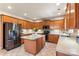 Well-lit kitchen featuring an island, tile backsplash, and stainless steel appliances at 1210 Langdon Terrace Dr, Indian Trail, NC 28079