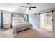 Bright main bedroom with a ceiling fan, a bed, and a barn door into the bathroom at 1210 Langdon Terrace Dr, Indian Trail, NC 28079