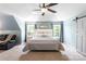 Bright main bedroom with a ceiling fan, a bed, and a sitting area at 1210 Langdon Terrace Dr, Indian Trail, NC 28079