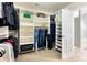 Well-organized walk-in closet with shelves, carpet, and a door to the bathroom at 1210 Langdon Terrace Dr, Indian Trail, NC 28079