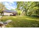 View of the expansive backyard and the house exterior with metal roof at 1221 Patterson St, Shelby, NC 28152
