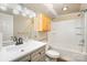 Standard bathroom featuring a shower-tub combo, single sink vanity and a wood storage cabinet at 1221 Patterson St, Shelby, NC 28152