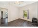 A bare bedroom with wood-look flooring, a window with curtain and neutral colored walls at 1221 Patterson St, Shelby, NC 28152