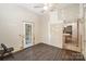 A bare bedroom with wood-look flooring, an exterior door to the backyard and pass through to kitchen at 1221 Patterson St, Shelby, NC 28152