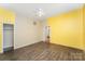 Bedroom showing yellow walls with a large closet space and wood look flooring at 1221 Patterson St, Shelby, NC 28152