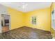 A cheerful bedroom features bright yellow walls, hardwood floors, and natural light from the windows at 1221 Patterson St, Shelby, NC 28152