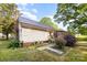 Home exterior showing siding, metal roof, partial stone chimney, and landscaping at 1221 Patterson St, Shelby, NC 28152