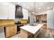 Renovated kitchen with stainless steel appliances, modern white cabinets, and a stylish black range hood at 1221 Patterson St, Shelby, NC 28152