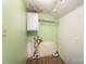 Small laundry room with shelving, plumbing fixtures and exposed water damage at 1221 Patterson St, Shelby, NC 28152