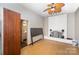 Living room with a whitewashed fireplace, ceiling fan, and hardwood floors, ready for relaxation at 1221 Patterson St, Shelby, NC 28152