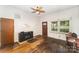 Cozy living room with hardwood floors, an electric fireplace, and natural light from the window at 1221 Patterson St, Shelby, NC 28152