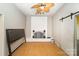 Cozy living room with a charming fireplace, ceiling fan, and light hardwood floors, inviting comfort at 1221 Patterson St, Shelby, NC 28152