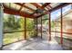 Screened in porch with metal roof, stained wood framing and a ceiling fan at 1221 Patterson St, Shelby, NC 28152