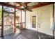 Screened in porch with metal roof, stained wood framing and a ceiling fan at 1221 Patterson St, Shelby, NC 28152