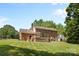 A brick home with a screened in porch and large backyard at 16565 Kimbolten Dr, Huntersville, NC 28078