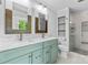 Stylish bathroom featuring a double vanity with marble countertop and modern glass shower at 16565 Kimbolten Dr, Huntersville, NC 28078