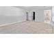 Bright bedroom with neutral carpet, multiple closets and natural light from large windows at 16565 Kimbolten Dr, Huntersville, NC 28078