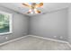 Cozy bedroom with plush carpet and ceiling fan, perfect for relaxation at 16565 Kimbolten Dr, Huntersville, NC 28078