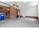 Spacious garage with painted walls and a door to the side yard at 16565 Kimbolten Dr, Huntersville, NC 28078