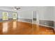 Spacious living room features hardwood floors, ample natural light, and a calming color palette at 16565 Kimbolten Dr, Huntersville, NC 28078