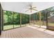 Relax in this screened porch, complete with ceiling fan and views of the lush backyard at 16565 Kimbolten Dr, Huntersville, NC 28078