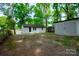 Backyard view of house with a large, shaded yard and detached structure at 1750 Oak Valley Dr, Gastonia, NC 28054